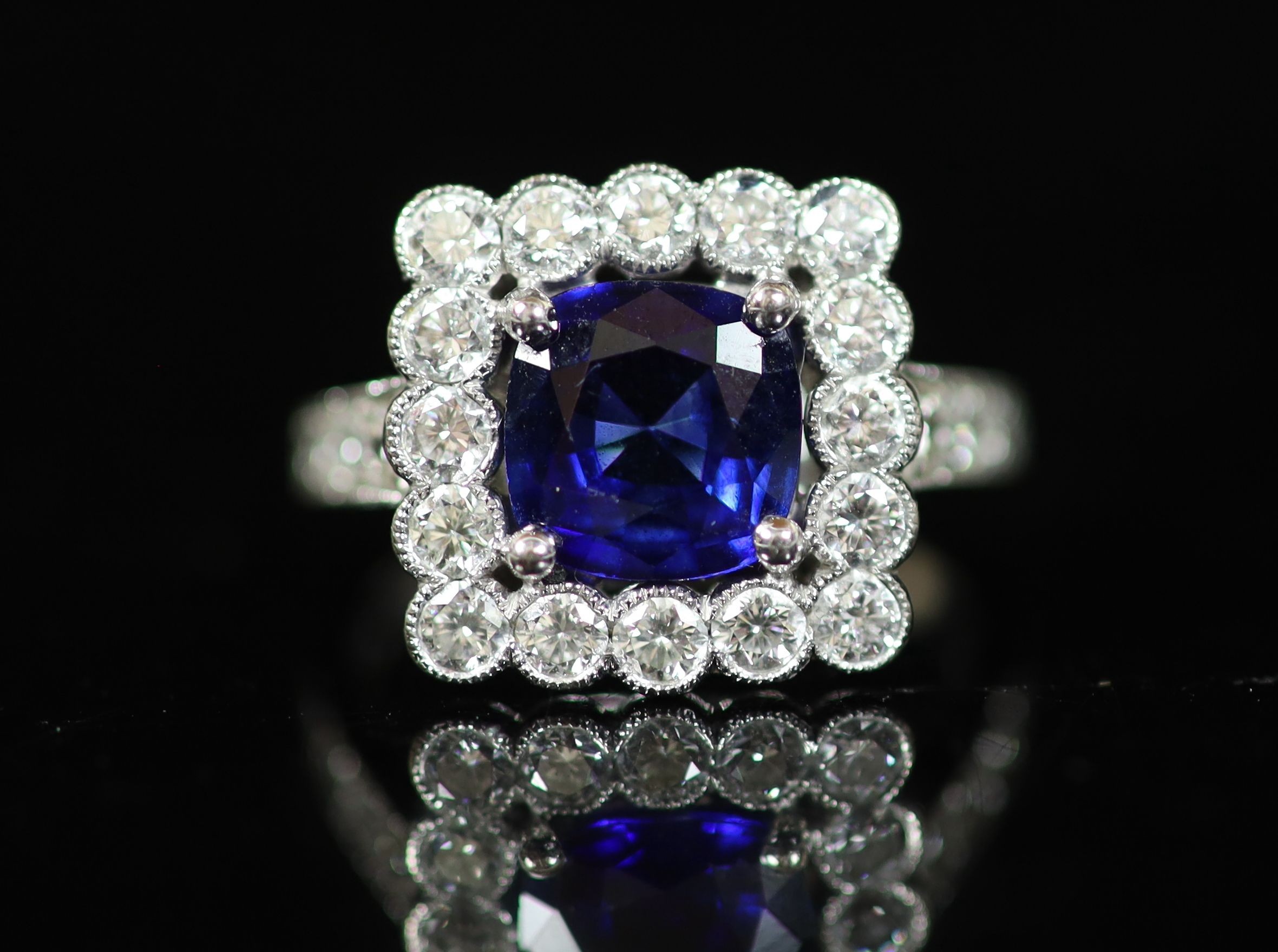 A modern 18ct white gold, sapphire and millegrain set diamond square cluster ring